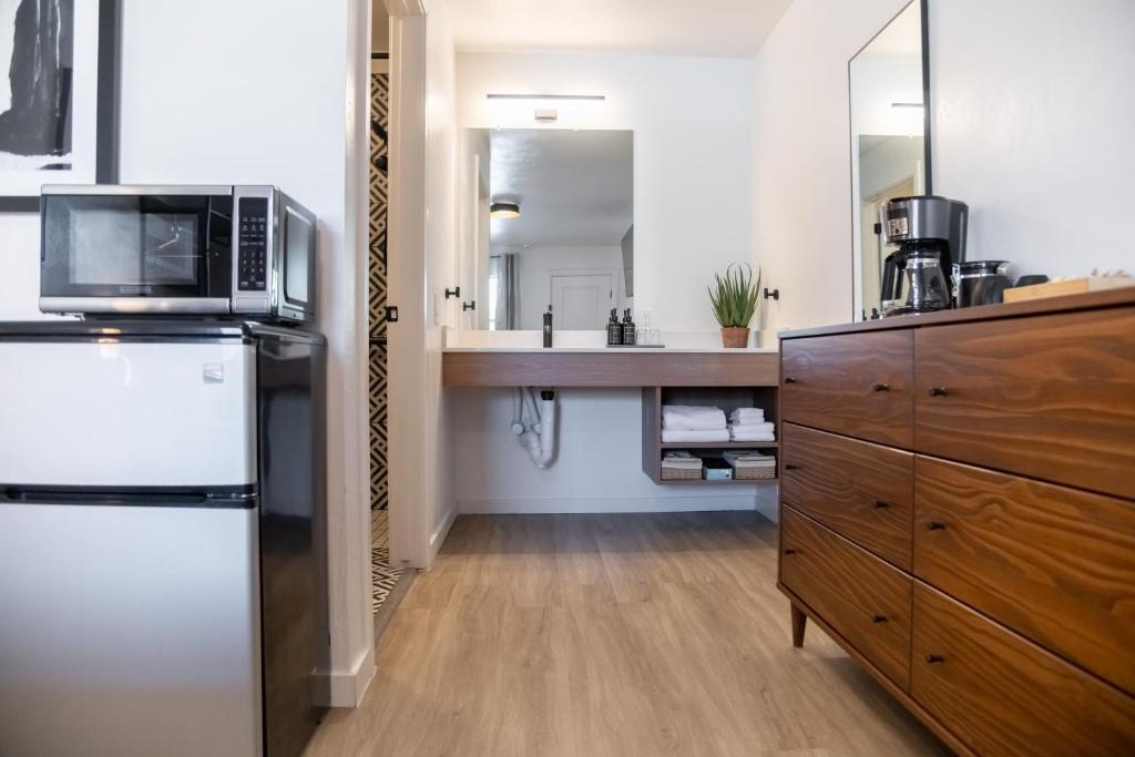 a kitchen with a refrigerator and a sink at High Creek Lodge and Cabins in Pagosa Springs