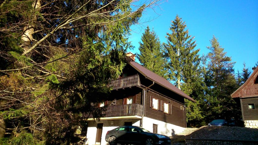 a house with a car parked in front of it at Apartments Jelka in Kranjska Gora