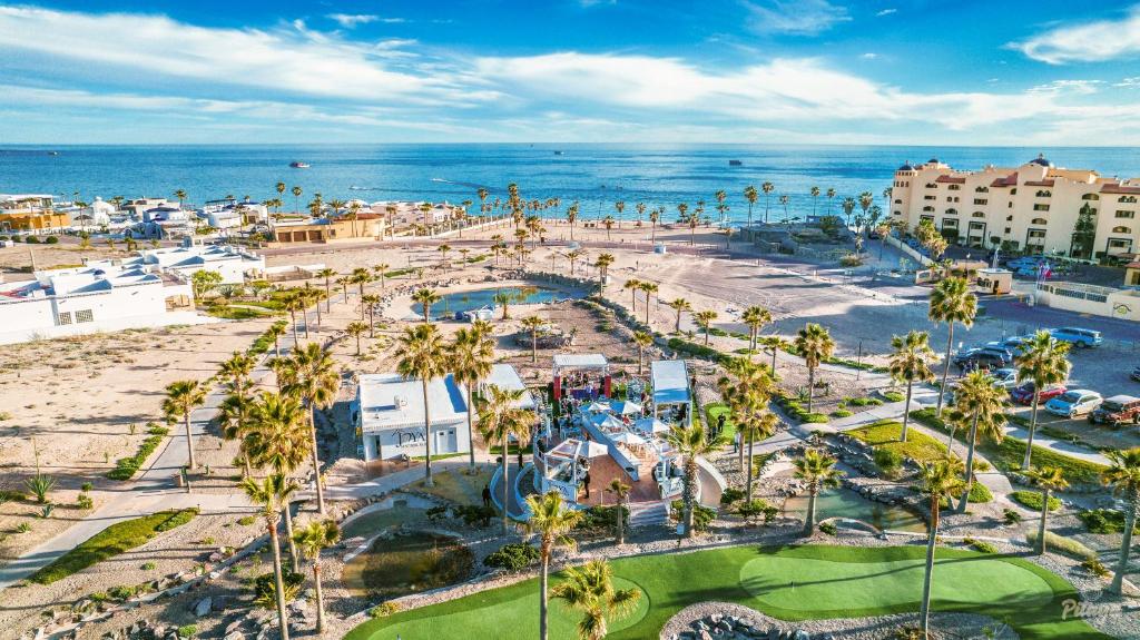 an aerial view of a resort with palm trees and the ocean at Casa Blanca Golf Villas in Puerto Peñasco
