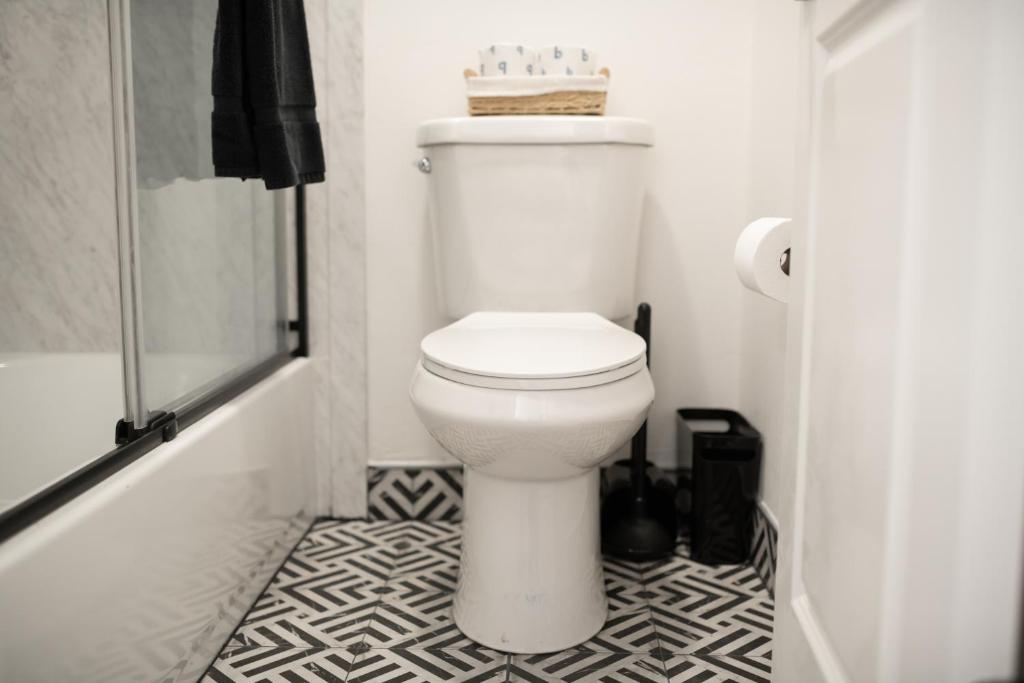 a white toilet in a bathroom with a shower at High Creek Lodge and Cabins in Pagosa Springs