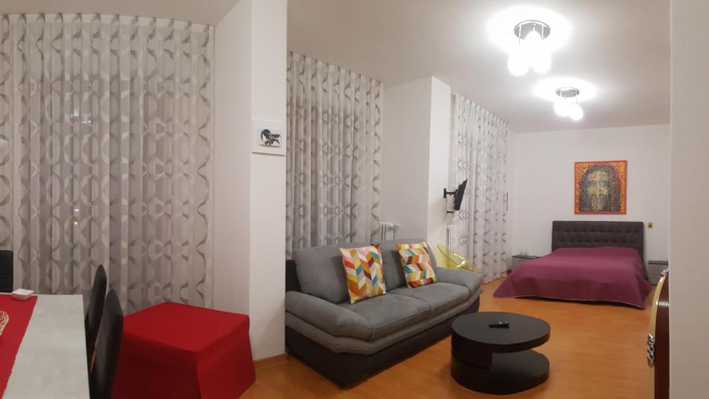 a living room with a couch and a bed at Casa Vacanze VITTORIA in Taranto
