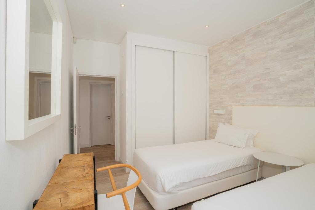 Postel nebo postele na pokoji v ubytování Dune Beach CoLiving