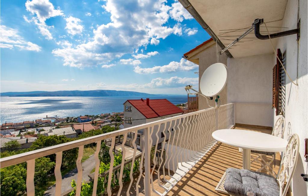 a balcony with a table and a view of the ocean at Nice Apartment In Senj With 2 Bedrooms And Wifi in Senj
