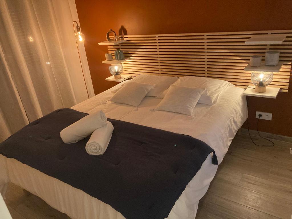 a bedroom with a large bed with two white pillows at Bienvenue à La Petite Virette in Saint-Rémy-de-Provence