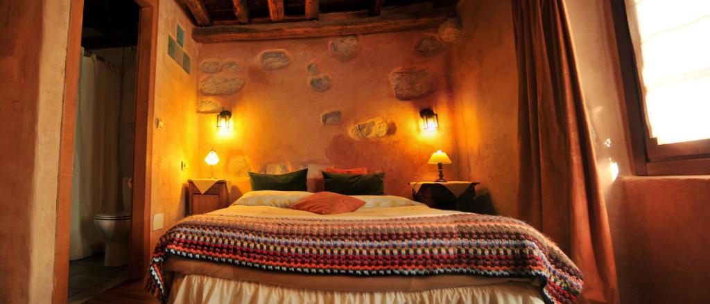 a bedroom with a large bed in a room at Casa Rural Ecológica Kaaño Etxea in Arrarats