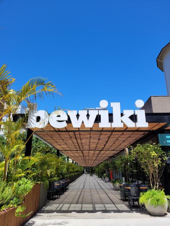 a sign for a restaurant on a sidewalk at Bewiki in Florianópolis