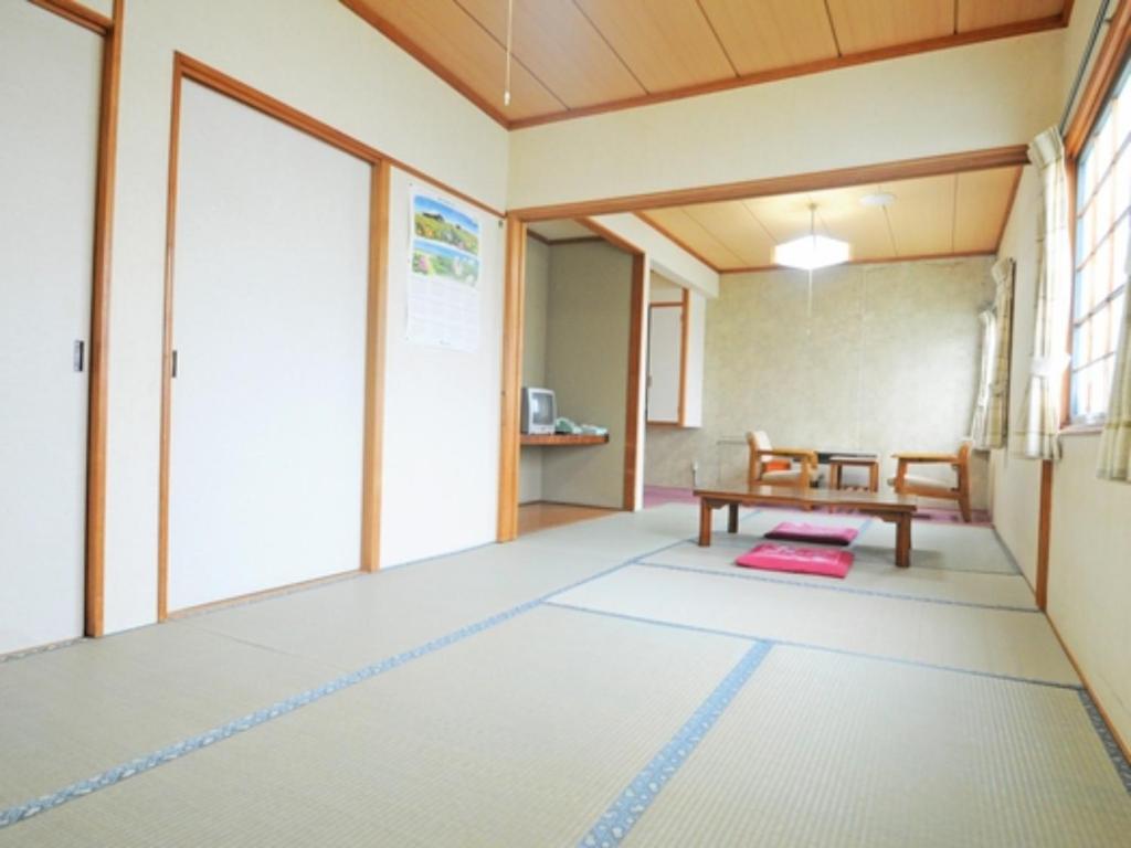 an empty room with a table in a classroom at Onsen Hotel Tsutsujiso - Vacation STAY 03267v in Kitami