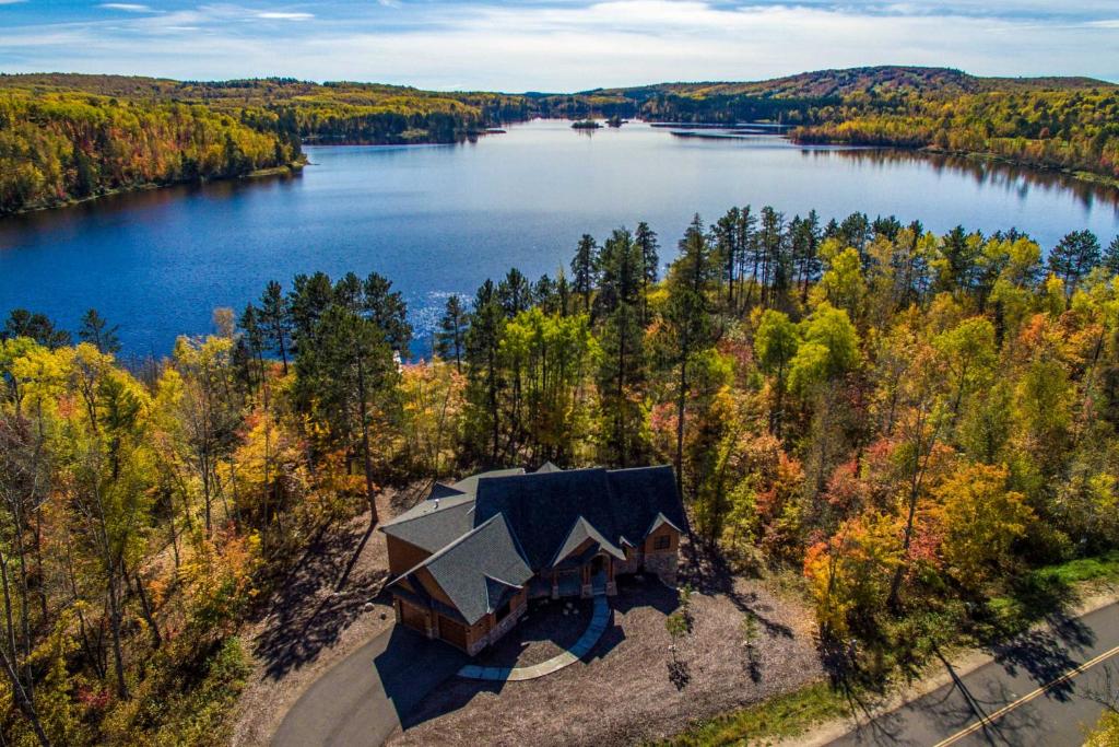 an aerial view of a house on the shore of a lake at Lakefront Giants Ridge Retreat Near Ski and Golf! in Biwabik