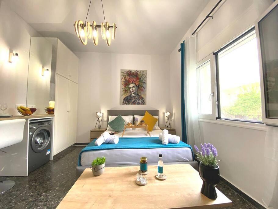 a bedroom with a bed with a blue bedspread at Artzy petit apartment close to the center in Heraklio Town