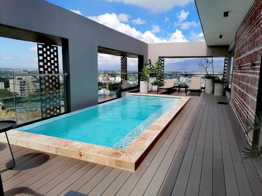 a swimming pool on the deck of a house at Paradise Room Rialto Residences in Santiago de los Caballeros
