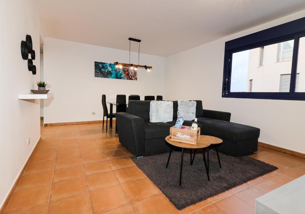 a living room with a couch and a table at Apartamento Aregoma in Puerto del Rosario