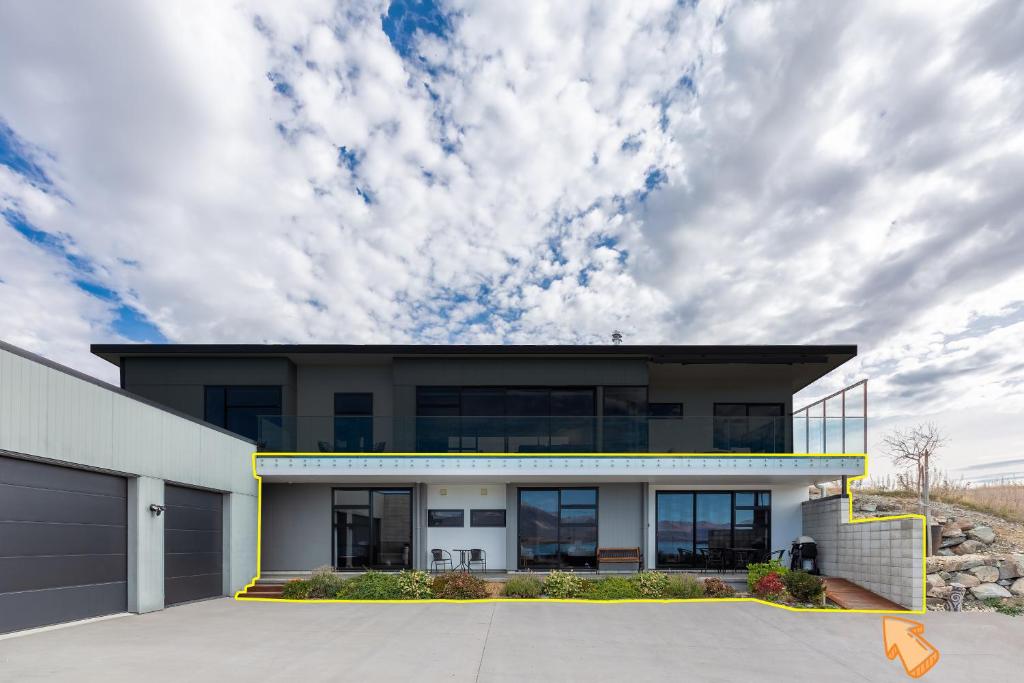 a modern house with a cloudy sky at Roto View - Beautiful views of Lake Tekapo in Lake Tekapo