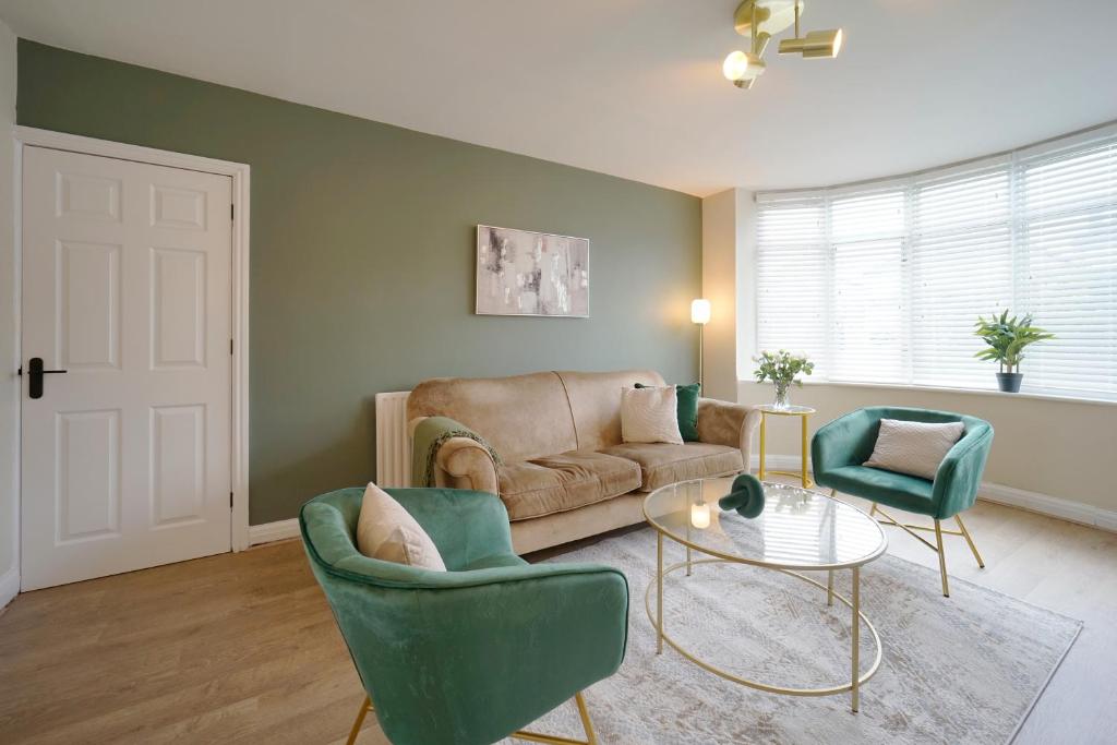 a living room with a couch and two chairs and a table at Stunning luxury 3 bed house with garden in North Leeds in Moortown