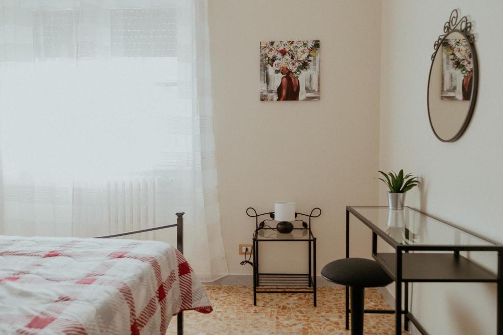 a bedroom with a bed and a desk and a mirror at La casa di Grazia in Rome
