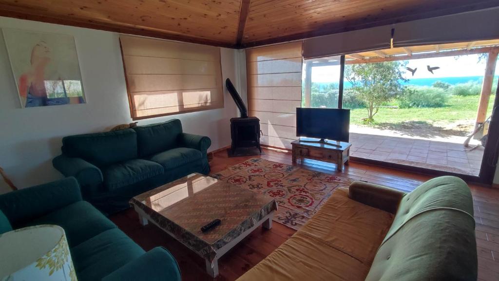 Una sala de estar con un sofá y un televisor. en El Abejaruco, en Tarifa