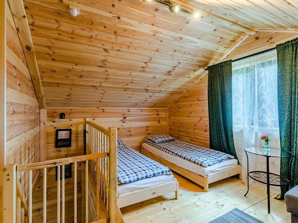 Posteľ alebo postele v izbe v ubytovaní Chata Leśna Polana