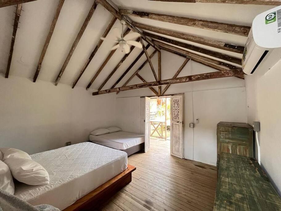 a bedroom with two beds in a room with a window at finca playa seca in Santa Fe de Antioquia