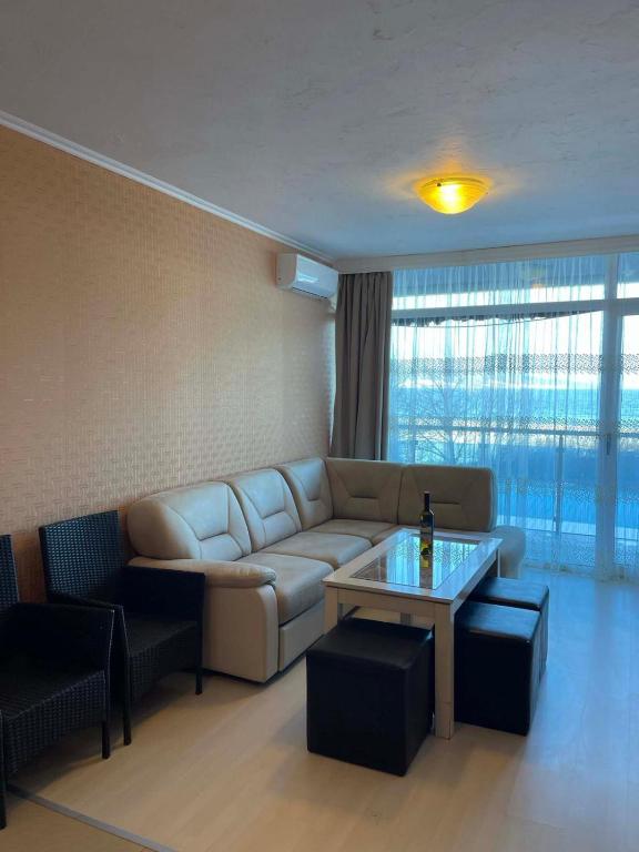a living room with a couch and a table at Apart hotel Gallery L in Sunny Beach
