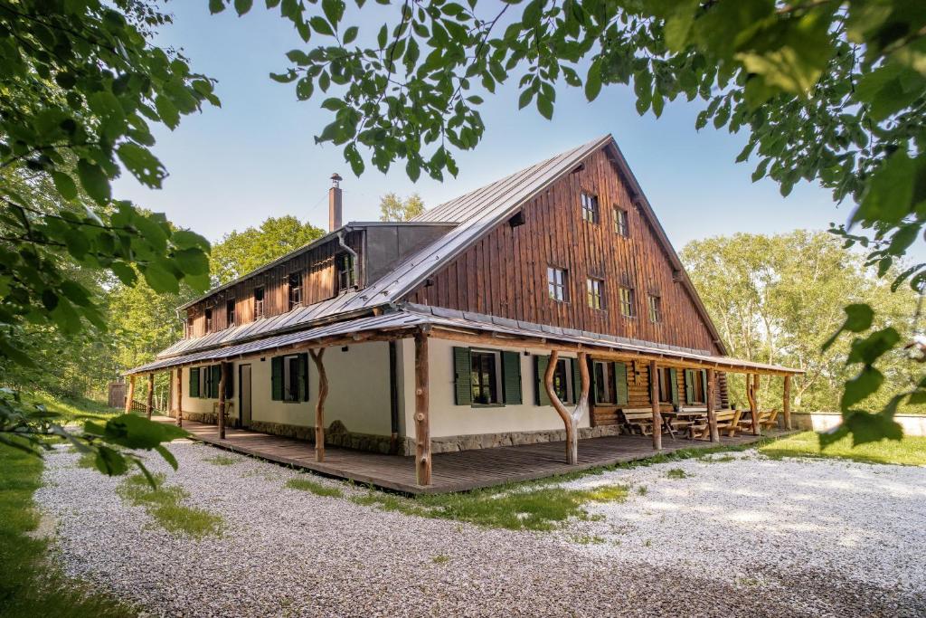 a large barn with a gambrel roof on a house at U Šumavských pramenů in Kašperské Hory