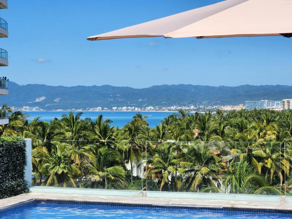 a view of the ocean from a resort swimming pool at Lovely 4 bedroom penthouse Terra PH23 QueridaEstancia in Nuevo Vallarta 