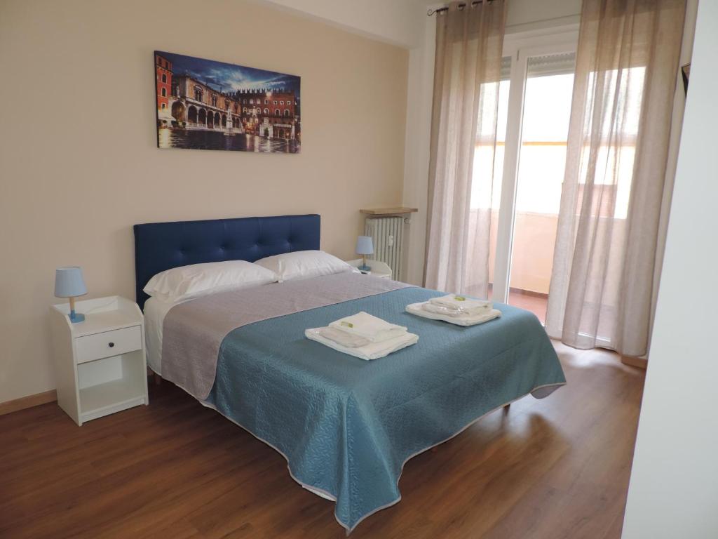 a bedroom with a bed with two towels on it at Sciesa Guest House in Verona