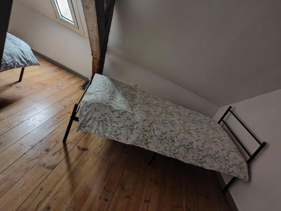 een bed in de hoek van een kamer bij At Dream appartement in Bergues