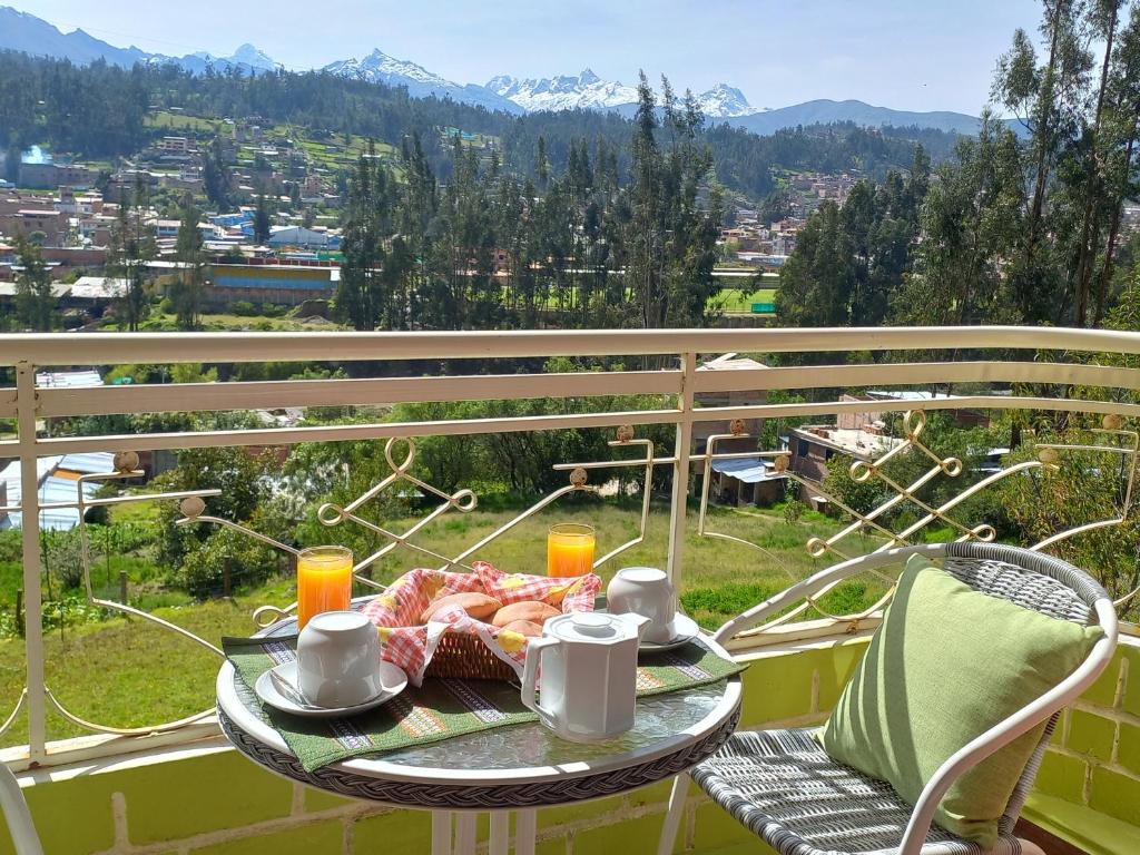 a table with a plate of food on a balcony at Fundo San Silvestre in Huaraz
