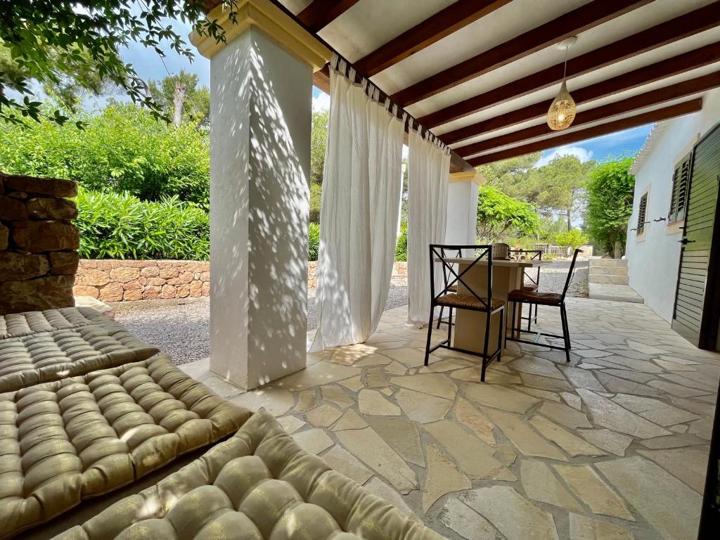 a patio with a couch and a table on a patio at Apartamentos Pinosol in Santa Eularia des Riu