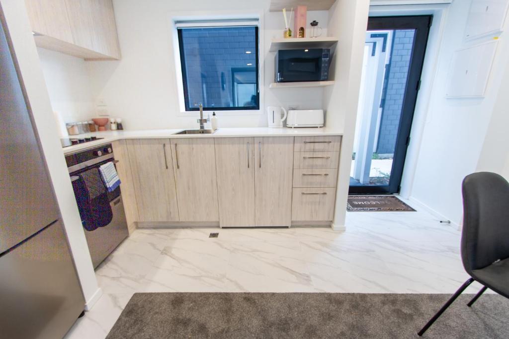 a kitchen with a sink and a counter top at Glamorous 2 bed CBD townhouse w/King bed in Christchurch