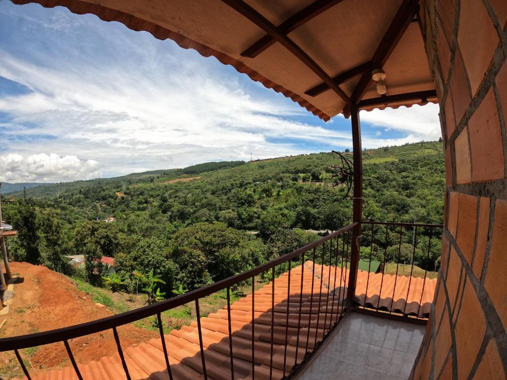 a balcony of a house with a view at VILLA ISABELLA in Curití