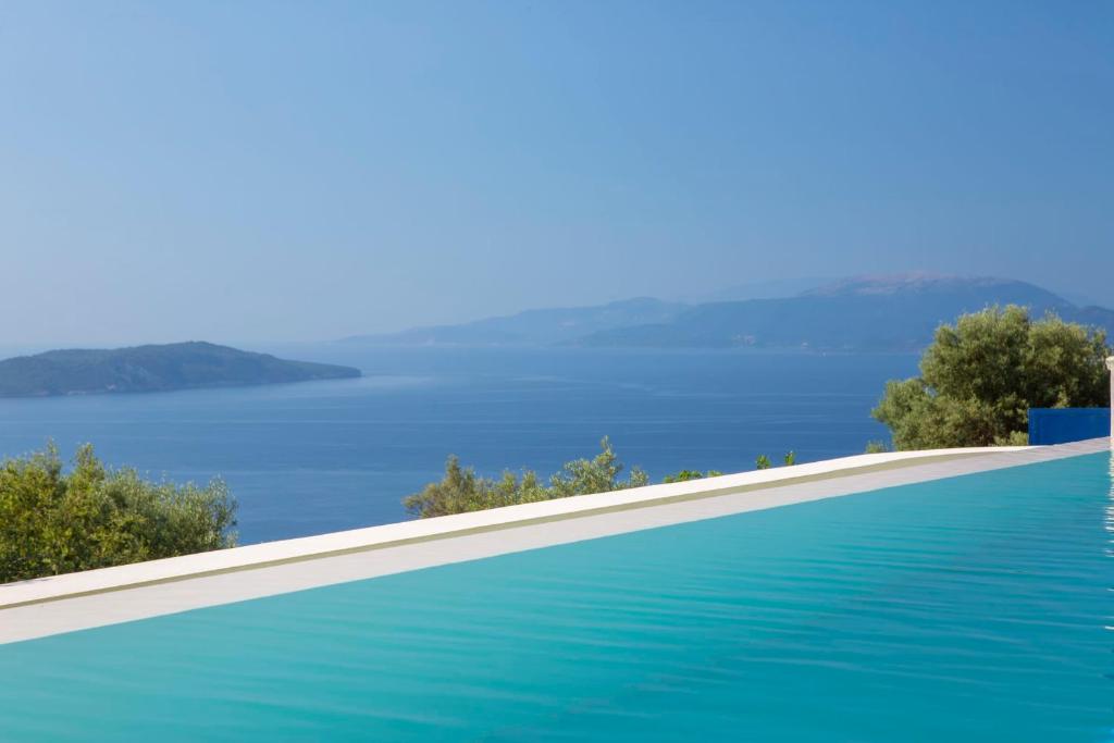 a swimming pool with a view of the water at Villa Careva - Beautiful Cozy and Luxury Villa in Sivota