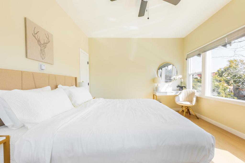a bedroom with a large white bed and a window at Cozy Sunny Brand-new Apt 1 Block From The Beach in Long Beach