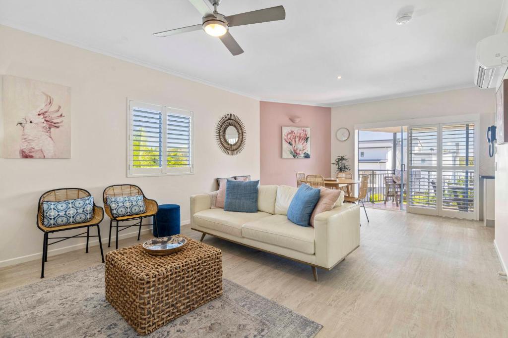 a living room with a couch and a table at Rimini Holiday Apartments in Noosaville