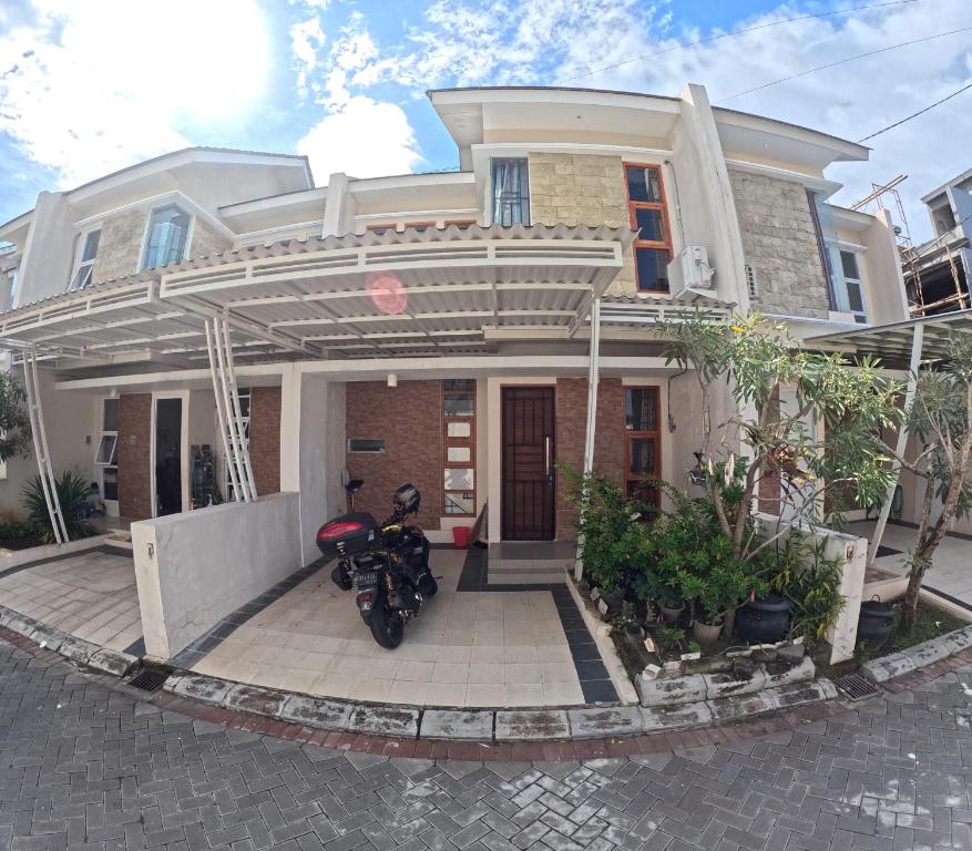 a motorcycle parked in front of a house at Ndalem Ngadimulyo Homestay Jogja Family Only in Ngabean