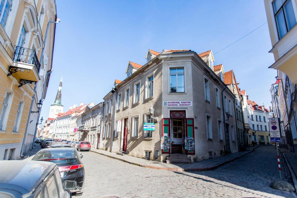 a building on a street with cars parked on the street at Old Town Hostel Alur in Tallinn