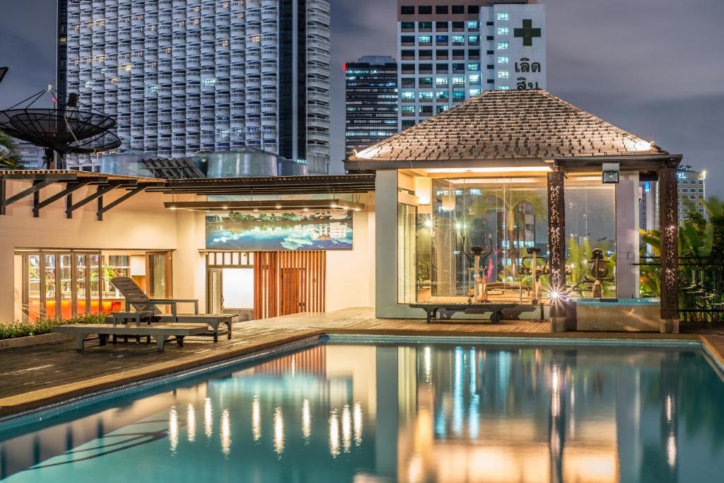 a house with a pool and a gazebo at The Grand Sathorn in Bangkok