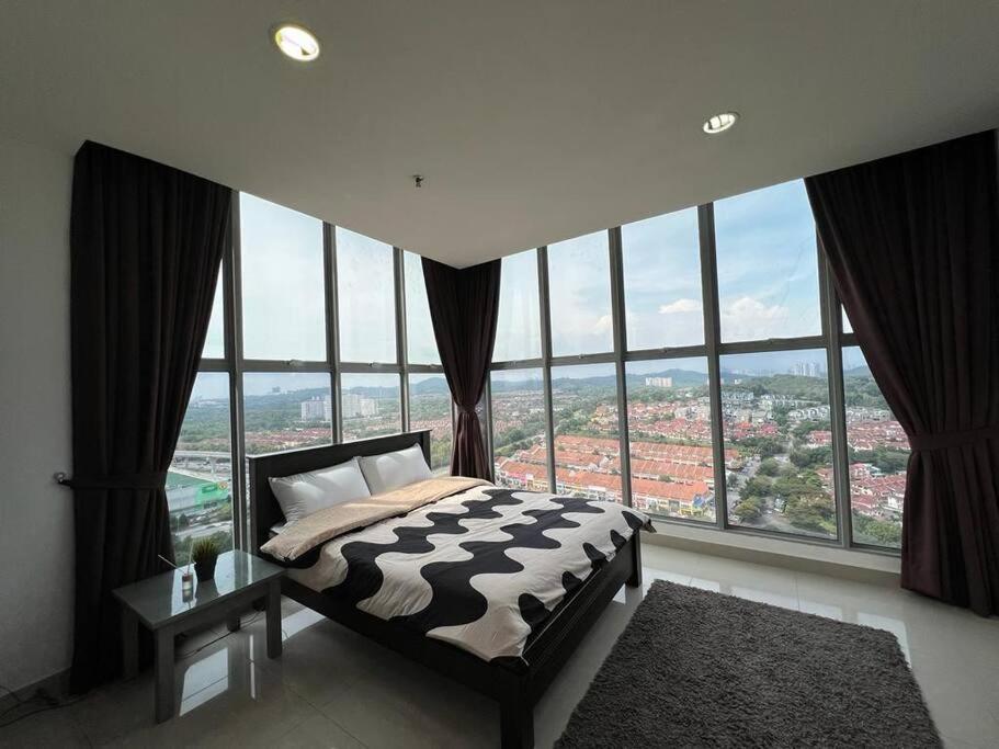 a bed in a room with large windows at 3Element*CornerUnit*Goodview* *NSK*Aeon*wifi in Seri Kembangan
