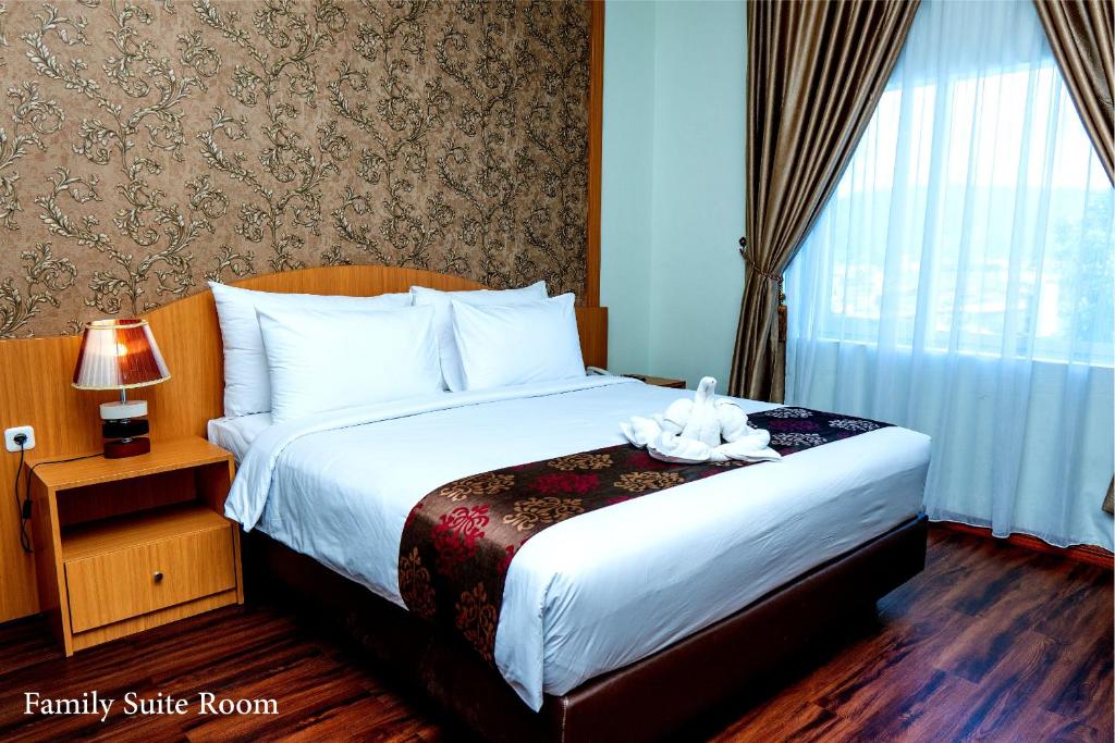 Postel nebo postele na pokoji v ubytování Grand Bayu Hill Hotel