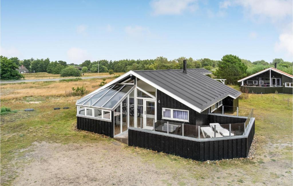 a small house with a roof on a field at 3 Bedroom Gorgeous Home In Fan in Fanø