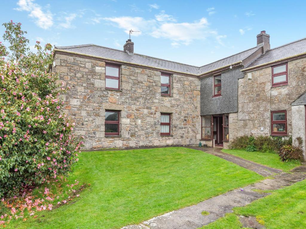 an old stone house with a large yard at The Loft in Carbis Bay