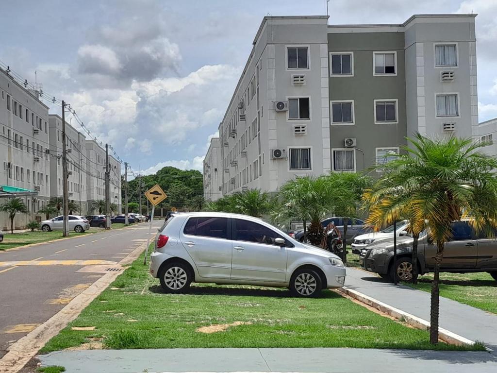 a white car parked on the side of a street at 4 ESTAÇÕES - apto em condomínio - 2 quartos com ar condicionado in Campo Grande