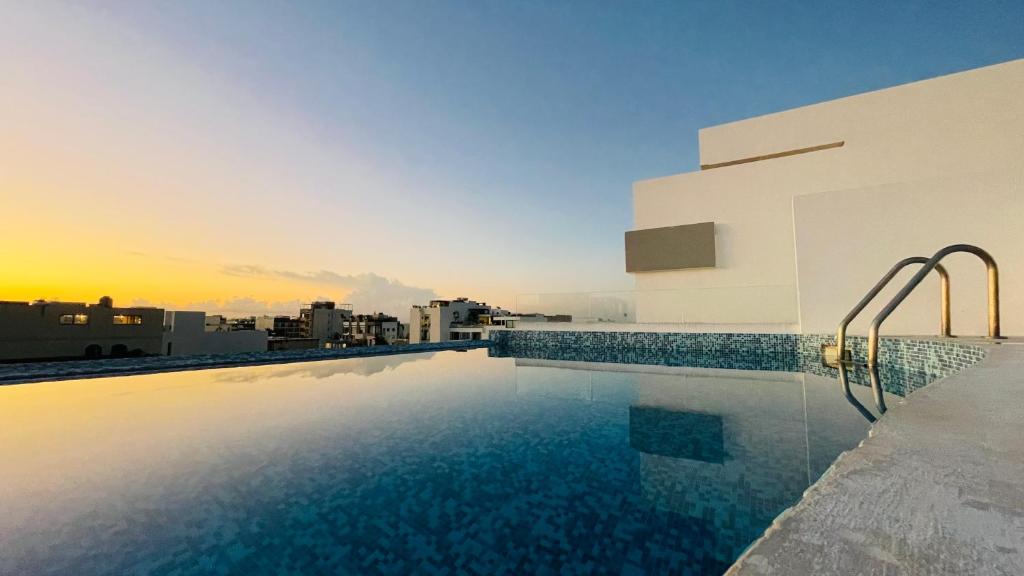 a swimming pool on the roof of a building at WINDAY HOTEL - Cerca 5a Avenida in Playa del Carmen