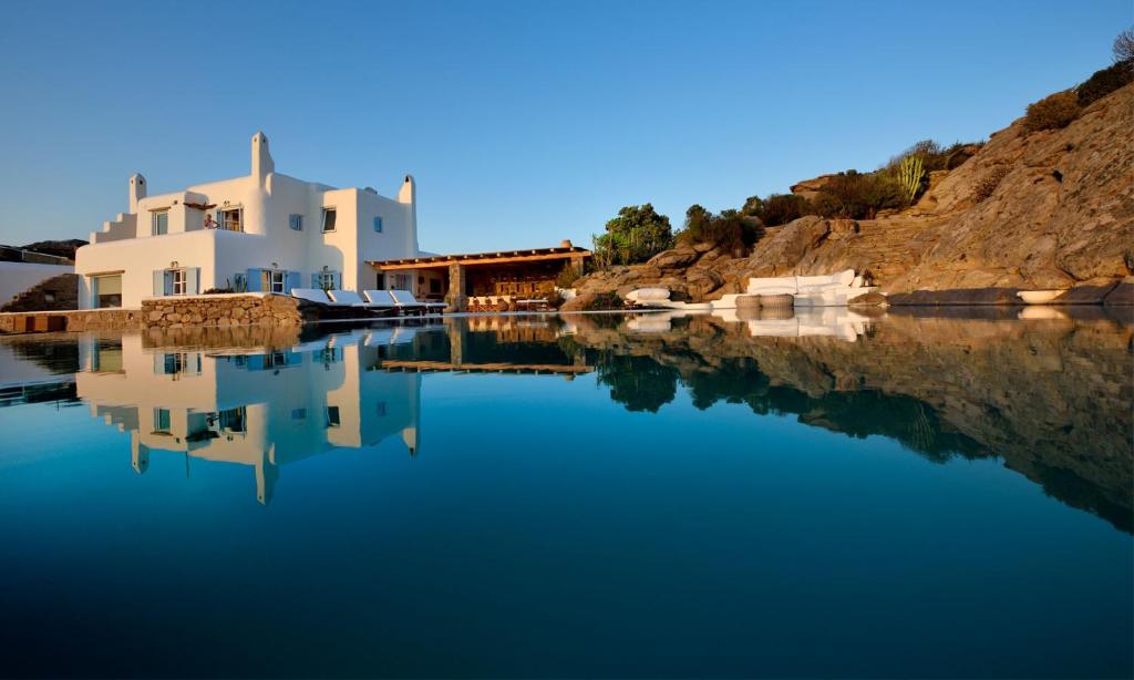 a reflection of a house in a body of water at Villa Karam in Mýkonos City