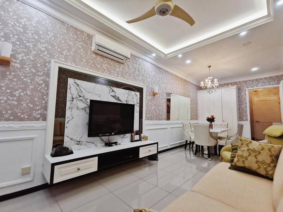 a living room with a flat screen tv on a wall at English Homestay Seaview Johor Bahru Permas 6 pax in Masai