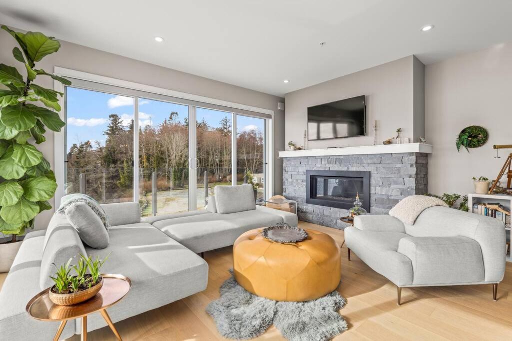 a living room with a couch and a fireplace at Waterfront - Serene Beauty of Sooke in Sooke