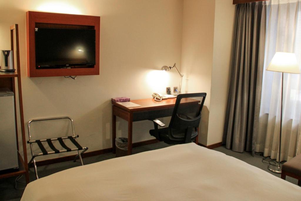 Postel nebo postele na pokoji v ubytování Guide Hotel Hsinchu Zhongyang
