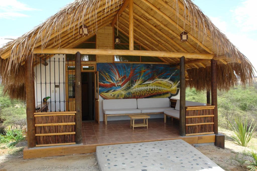 a gazebo with a fish painting on it at Amazonia Bungalow in Máncora