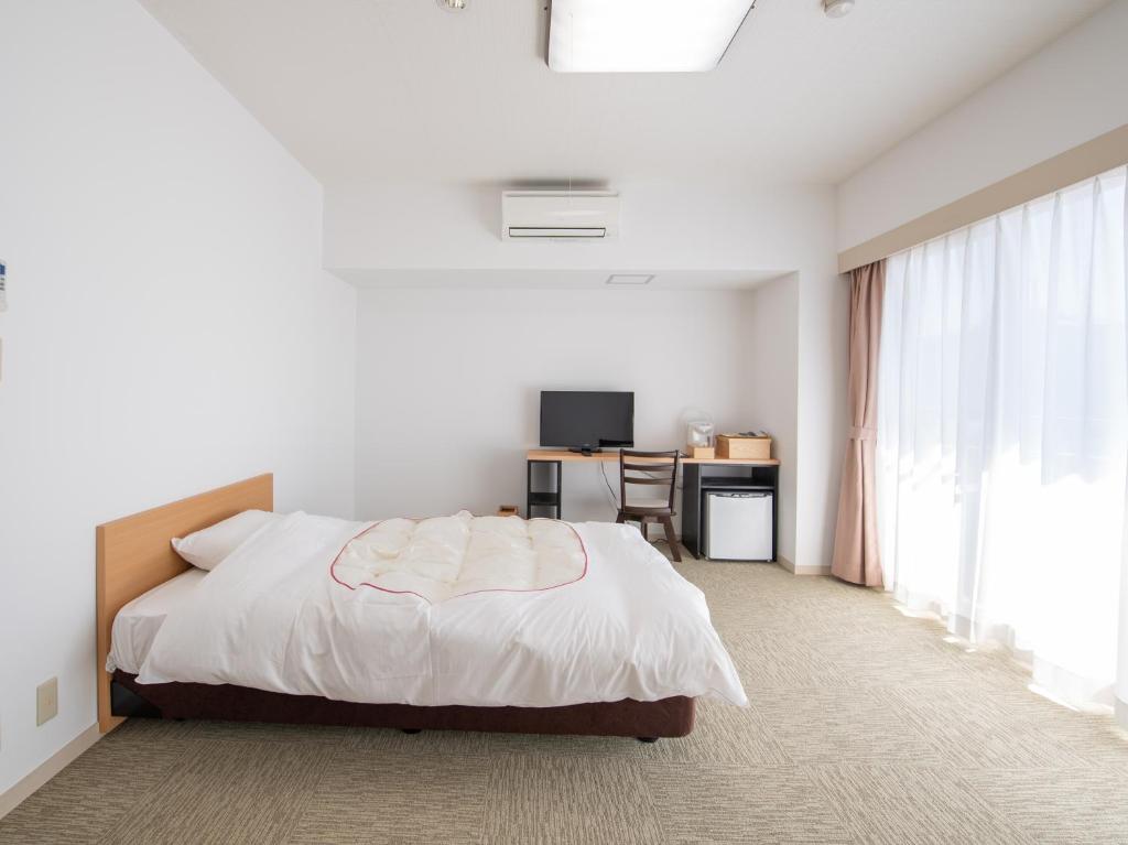 Postel nebo postele na pokoji v ubytování Chateraise Lodge Kasugai