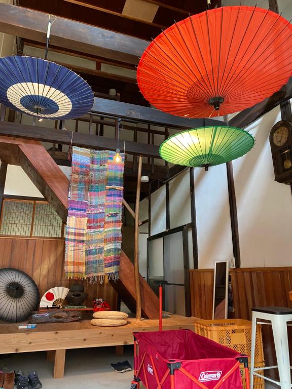 a room with umbrellas hanging from the ceiling at 跳びしまBASE in Mitarai