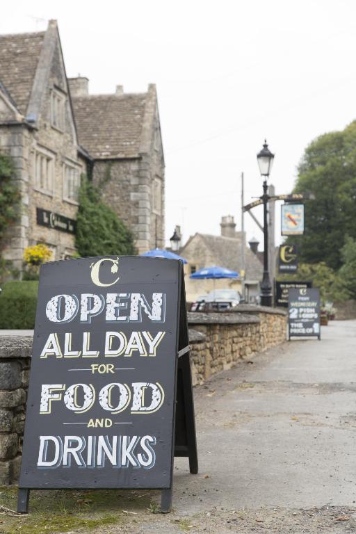 a sign that says open all day for food and drinks at The Colesbourne Inn in Colesbourne